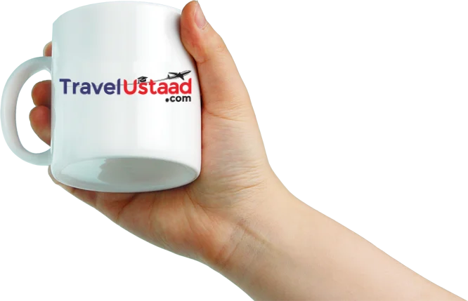 Girl hand holding mug having travelustaad.com Logo